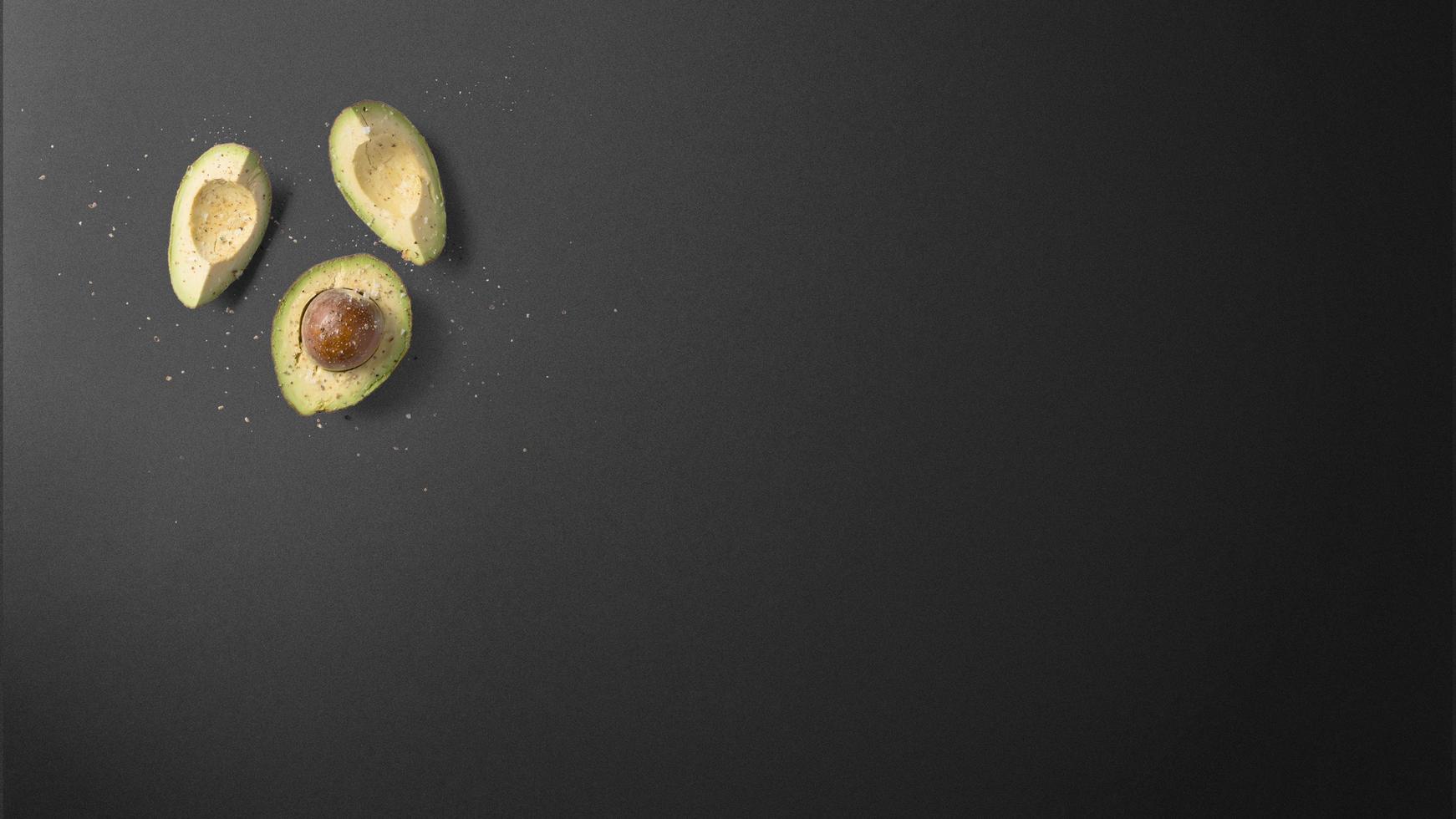 Avocado on dark grey table photo