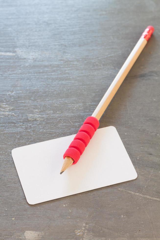 Name card with a pencil on a grey background photo