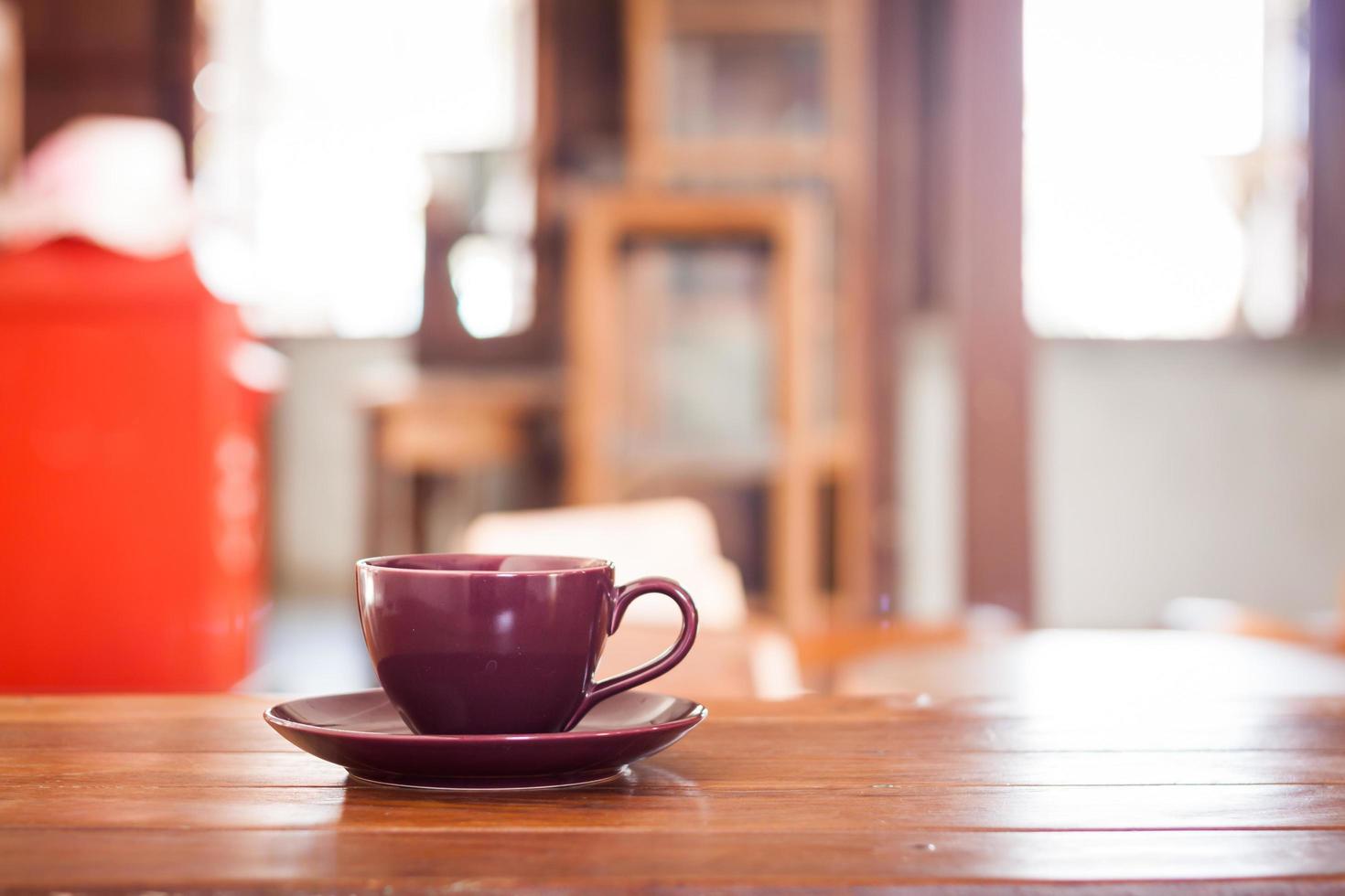 Purple coffee cup on a wooden table photo