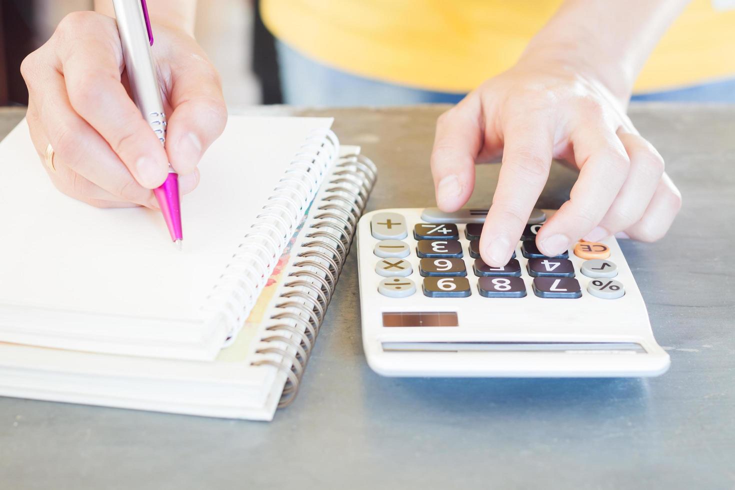 Close-up of a person making calculations photo