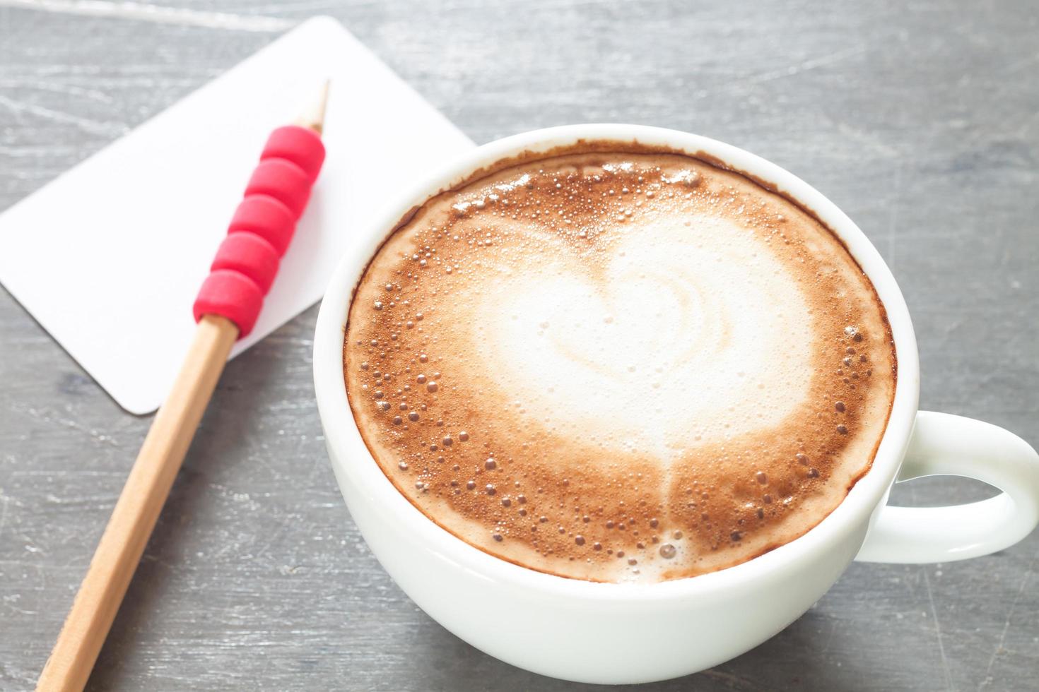 Latte with a business card and pencil photo