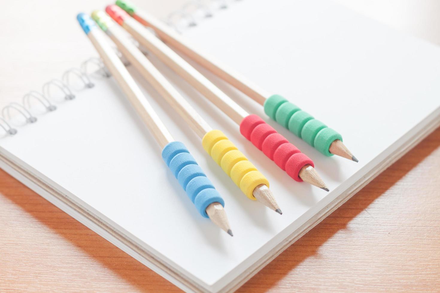 Pencils on a notebook on a desk photo