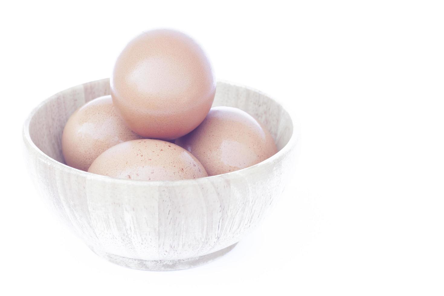 Eggs in a wooden bowl photo