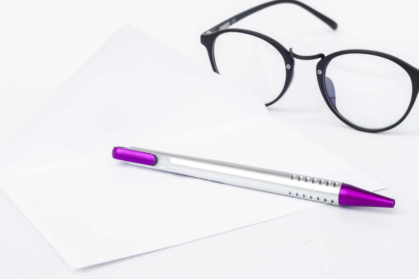 Envelope with a pen and glasses photo