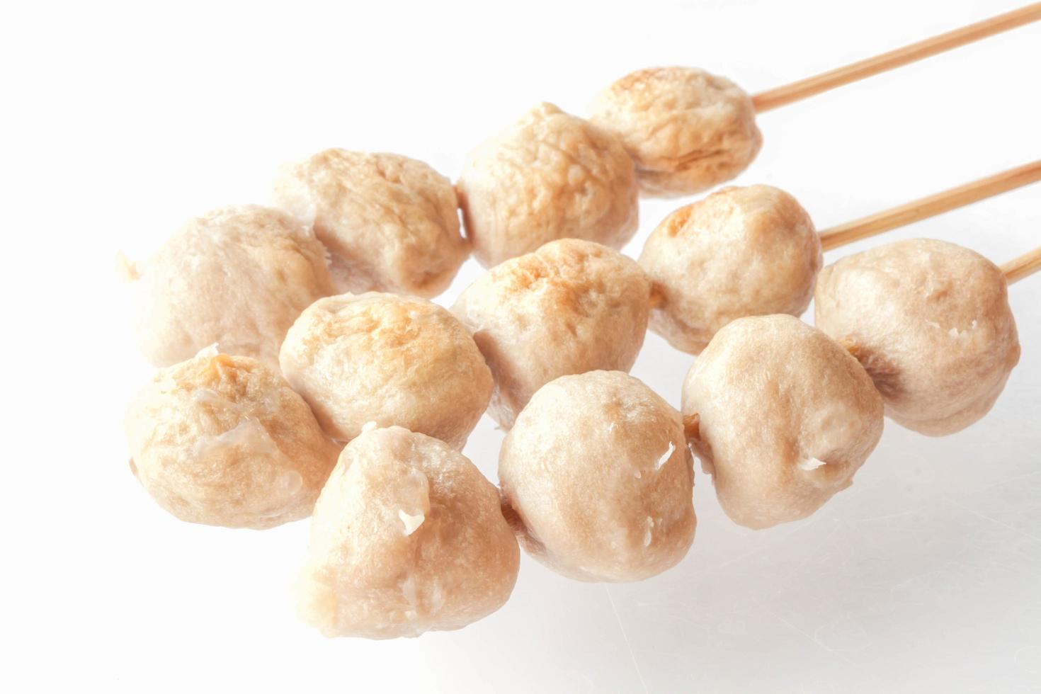 Pork meatballs on skewers on a white background photo