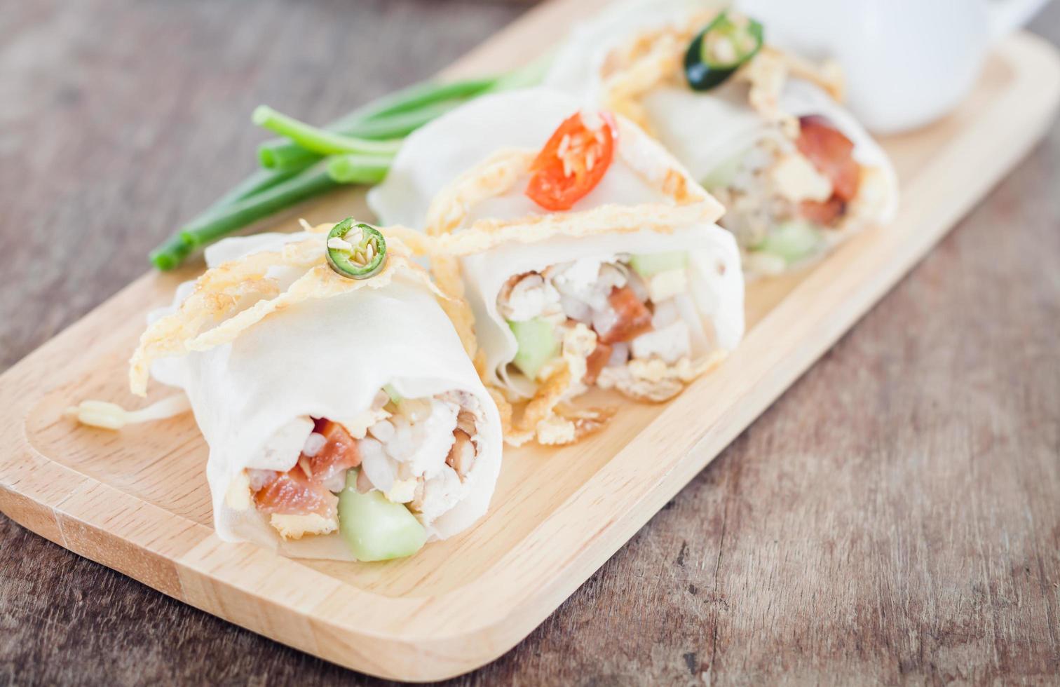 Fresh spring rolls on a wooden tray photo