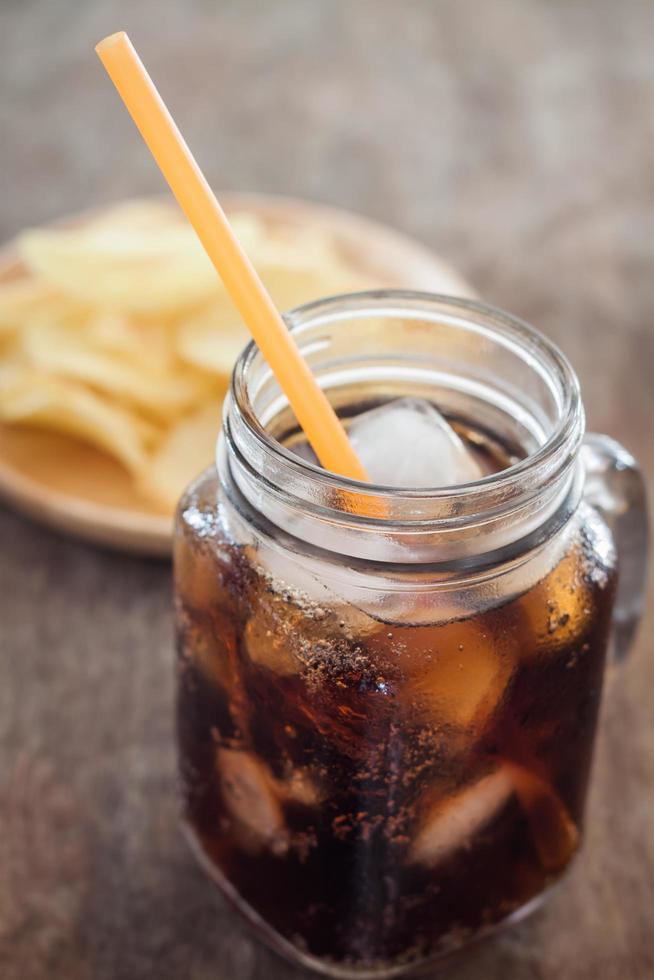 Soda with potato chips photo