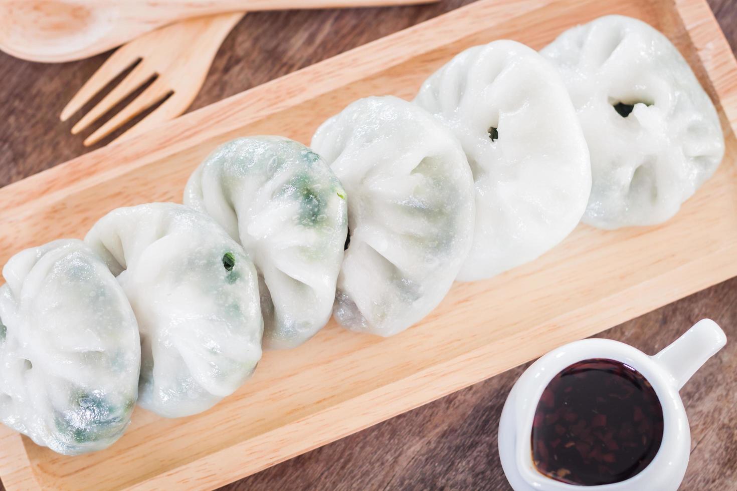 Close-up of dim sum and dipping sauce photo