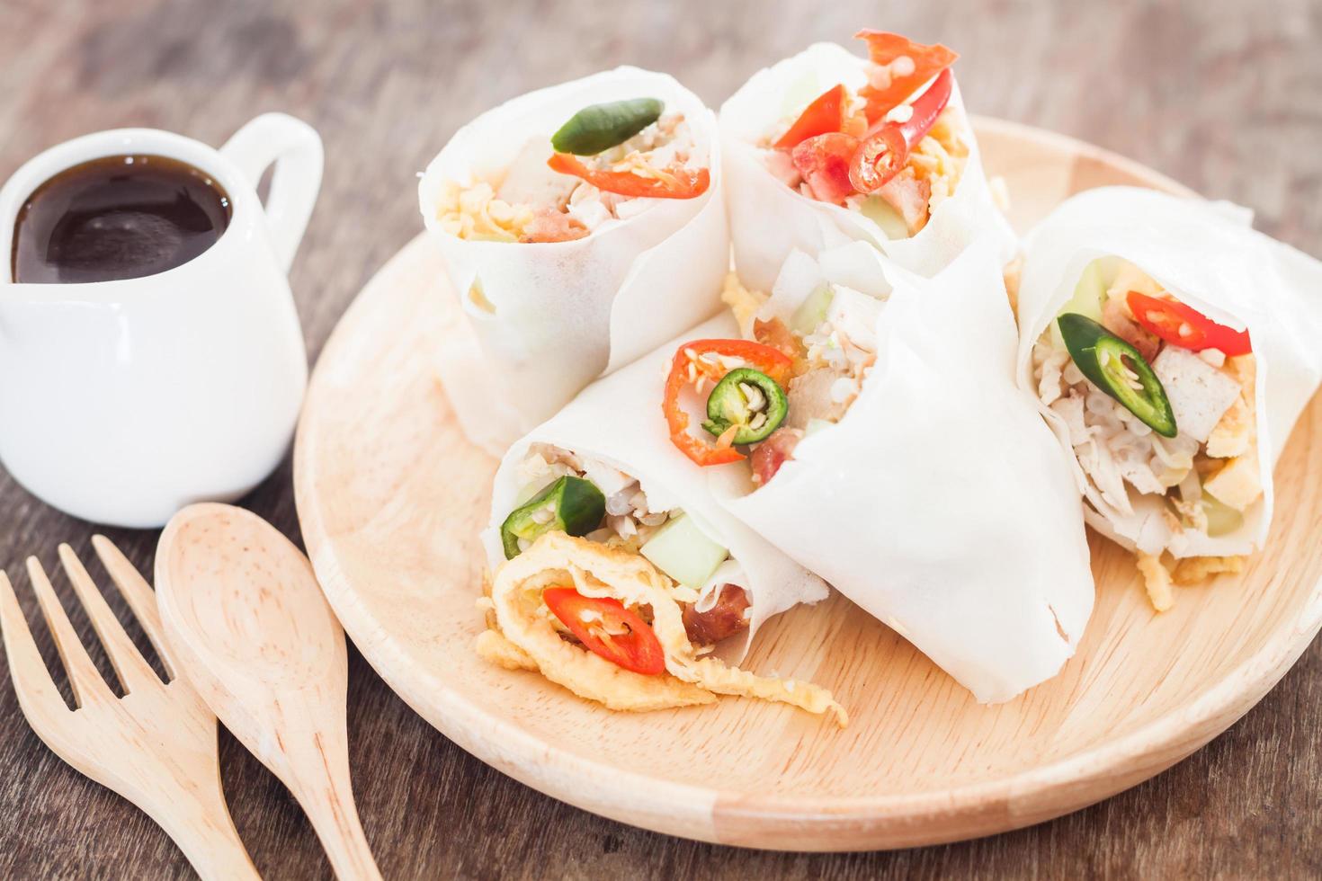 Spring rolls on a wooden plate photo