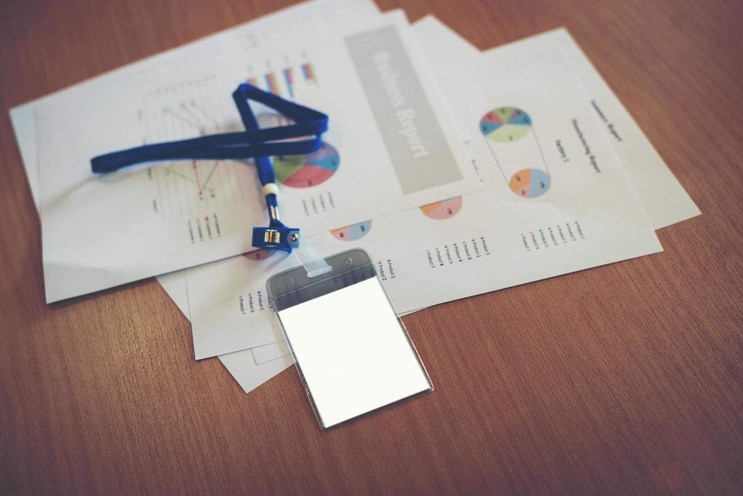 Business documents with blank employee card on work space photo