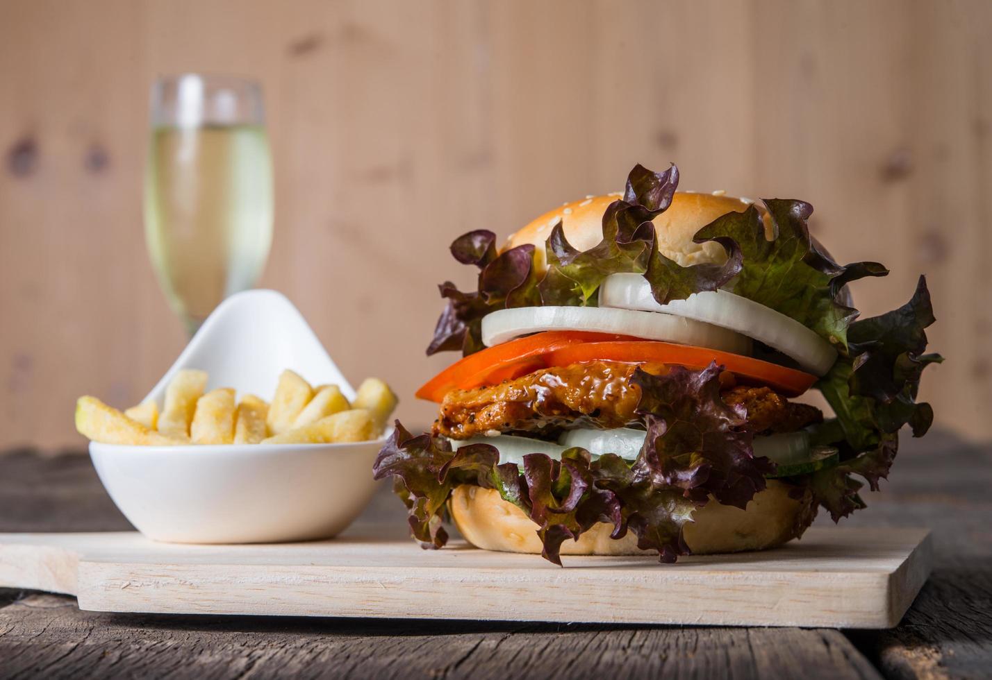 Homemade chicken burger with champagne and french fries photo