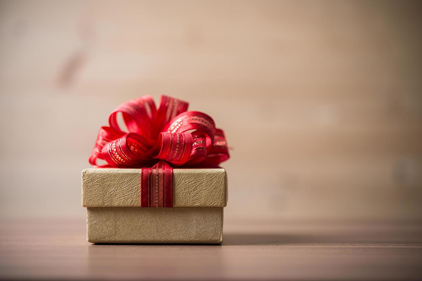 Small gift box on wooden background photo