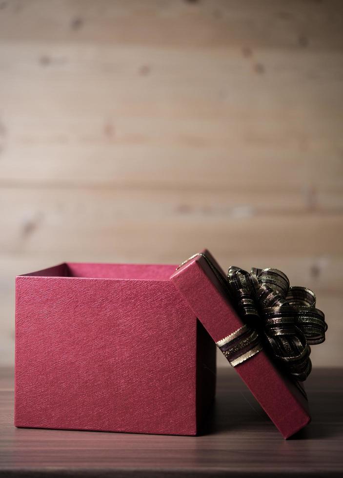 Small gift box on wooden background photo