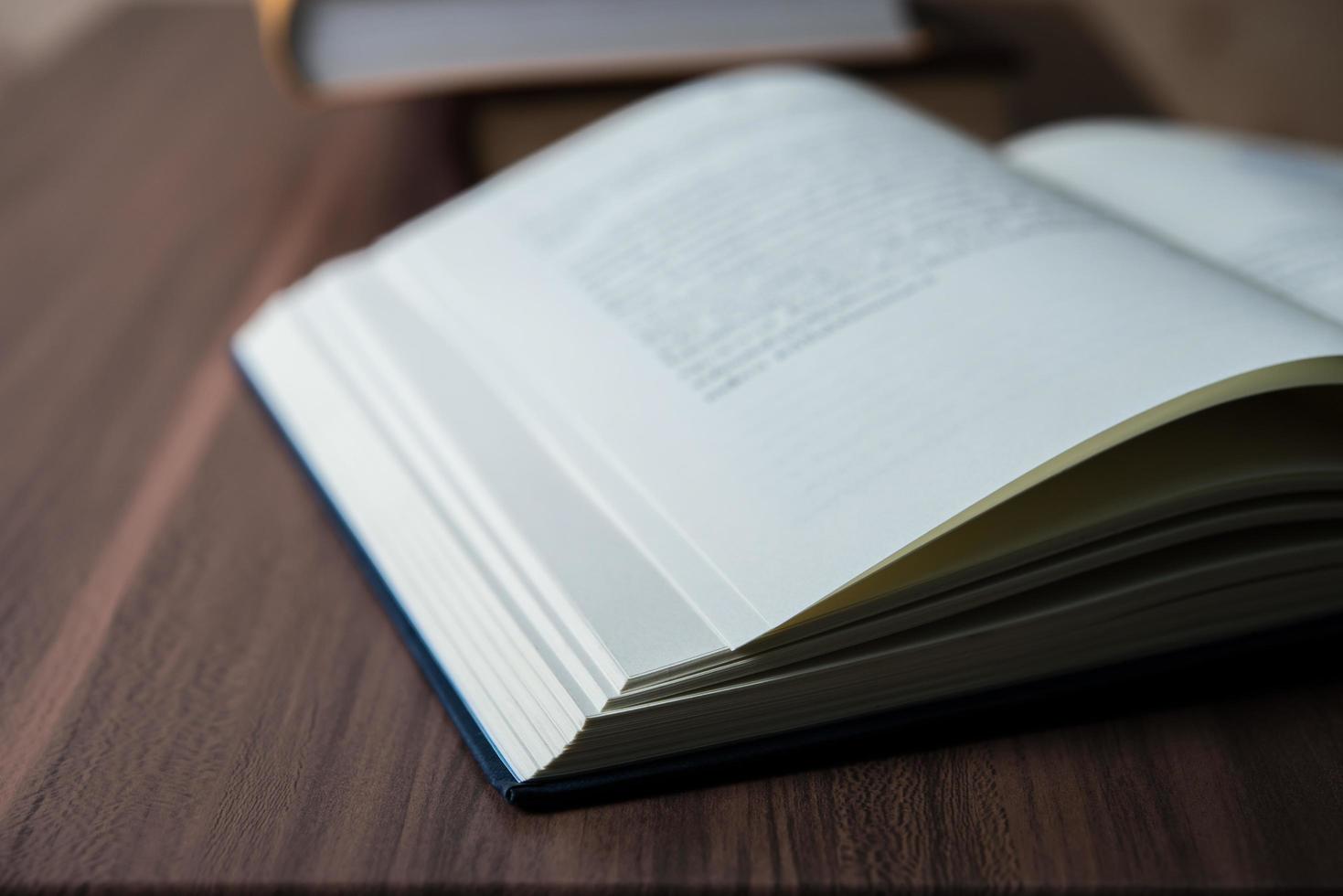 Close-up of an opened book on a wooden table photo