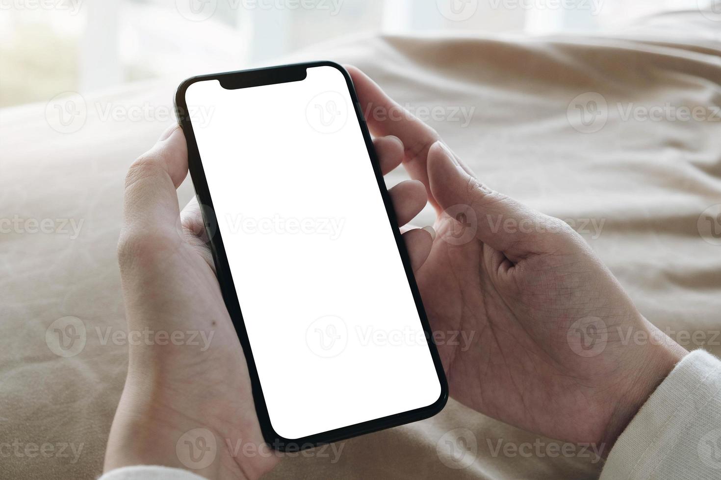 Top view of woman holding blank screen mobile phone photo