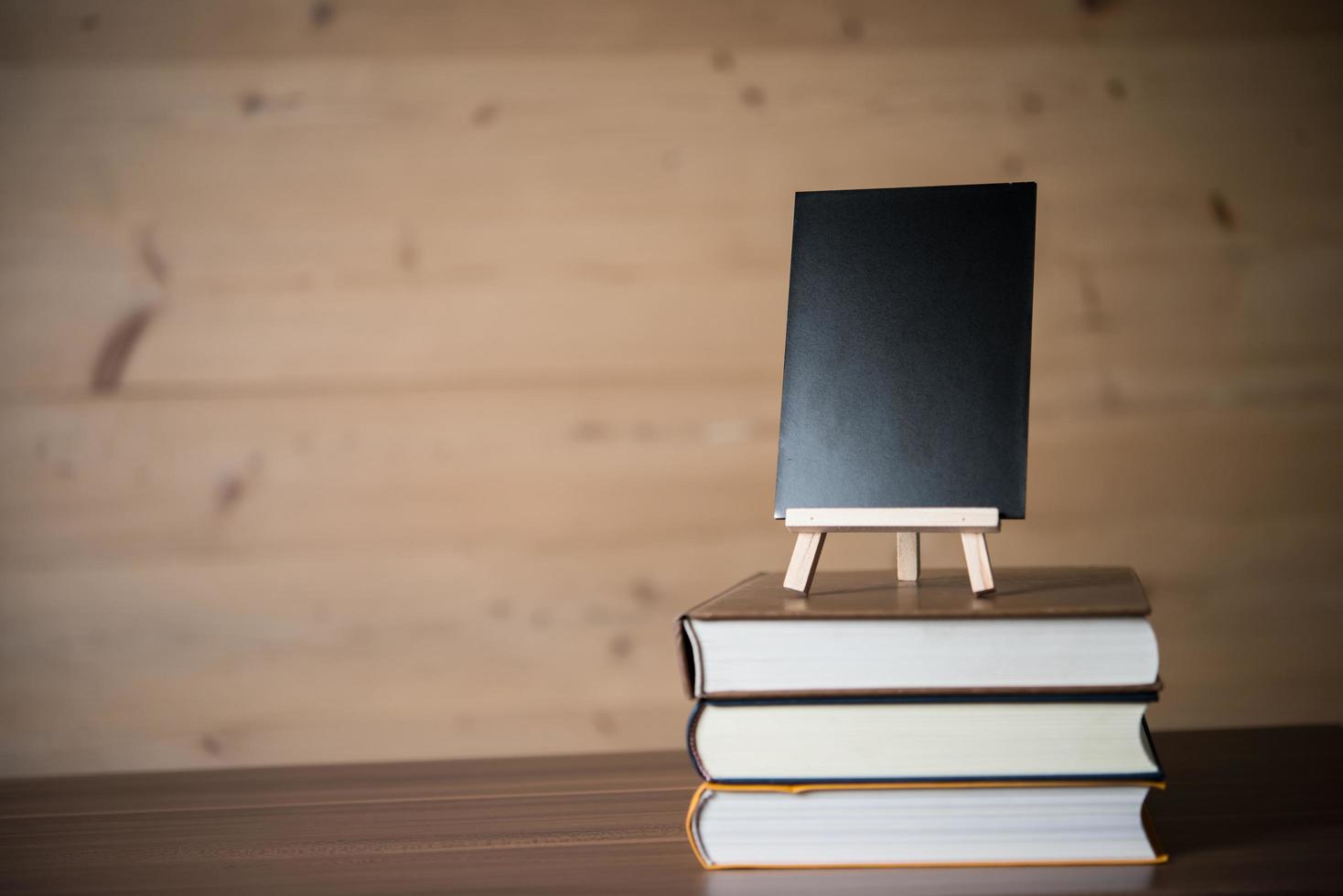 Small chalkboard and a stack of books photo