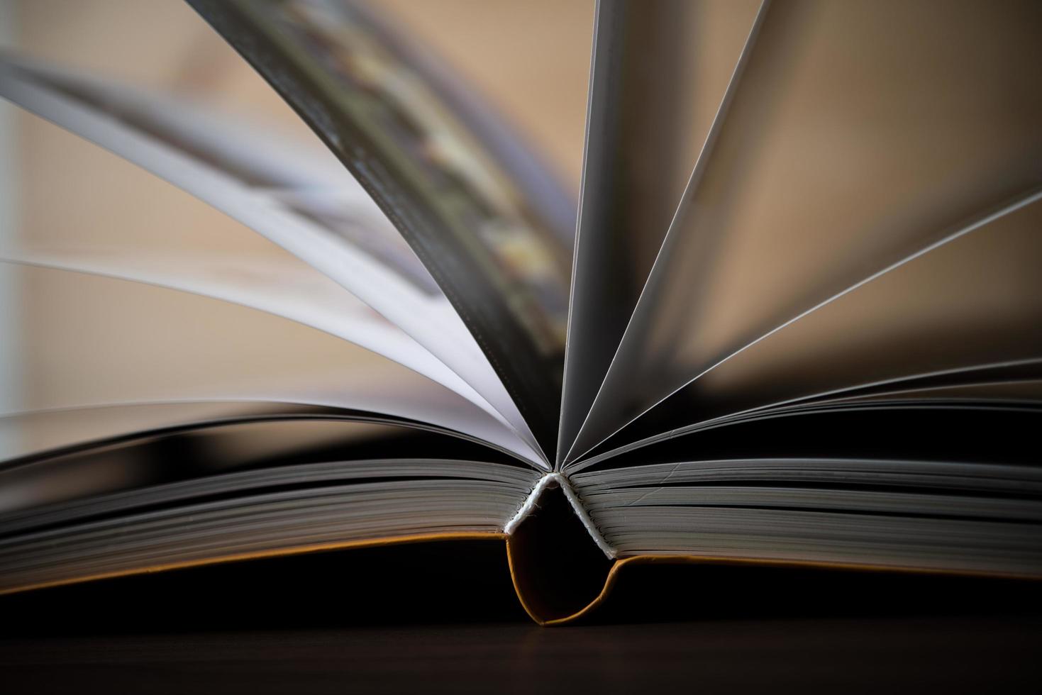 Close-up of an opened book on a wooden table photo