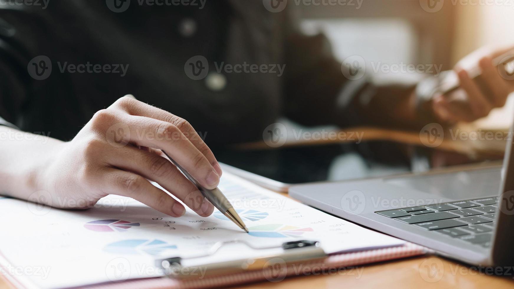 Businessman working with documents graphs at office desk photo