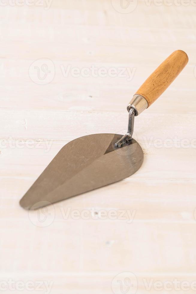 Garden trowel on wood background photo