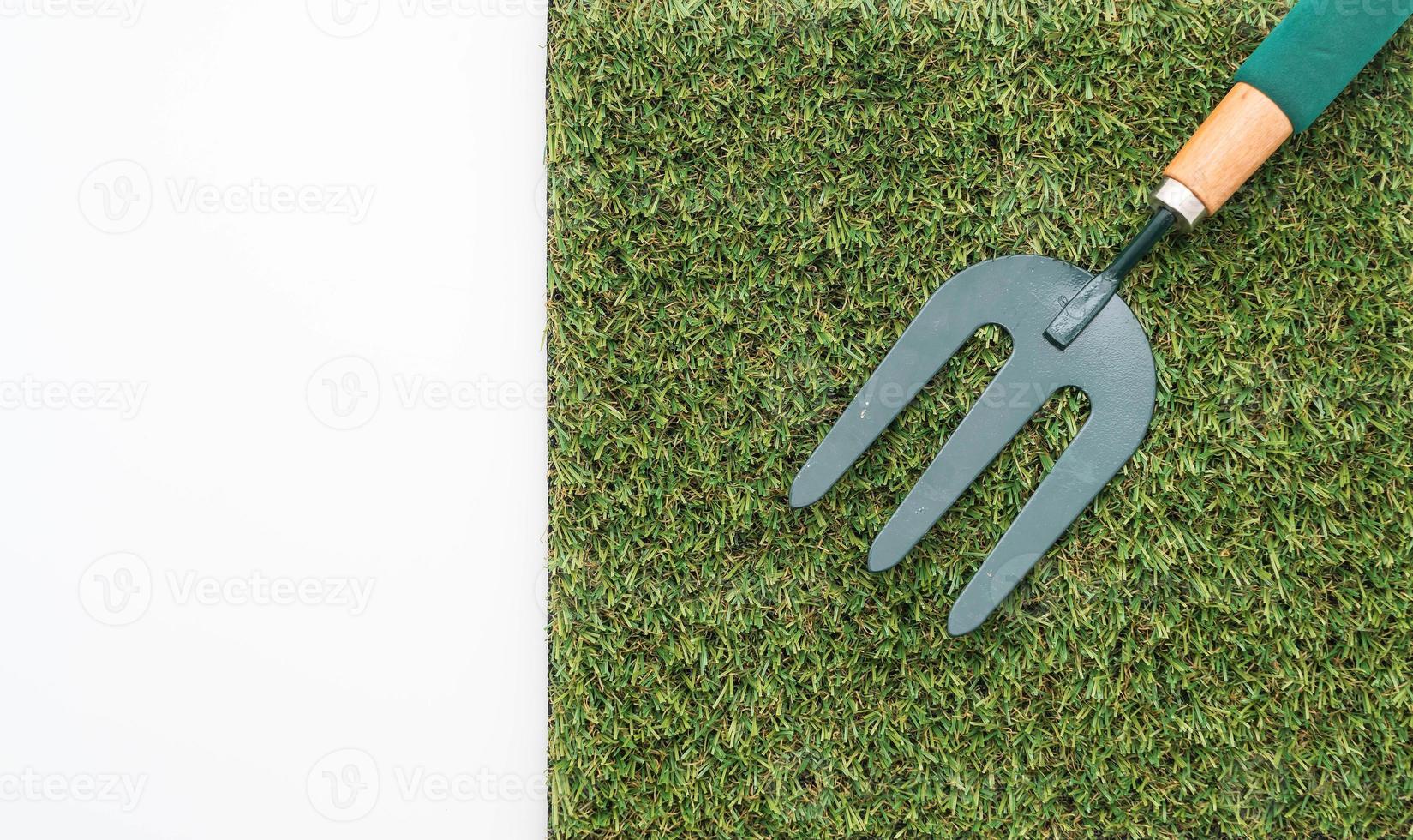 Small garden rake on grass photo