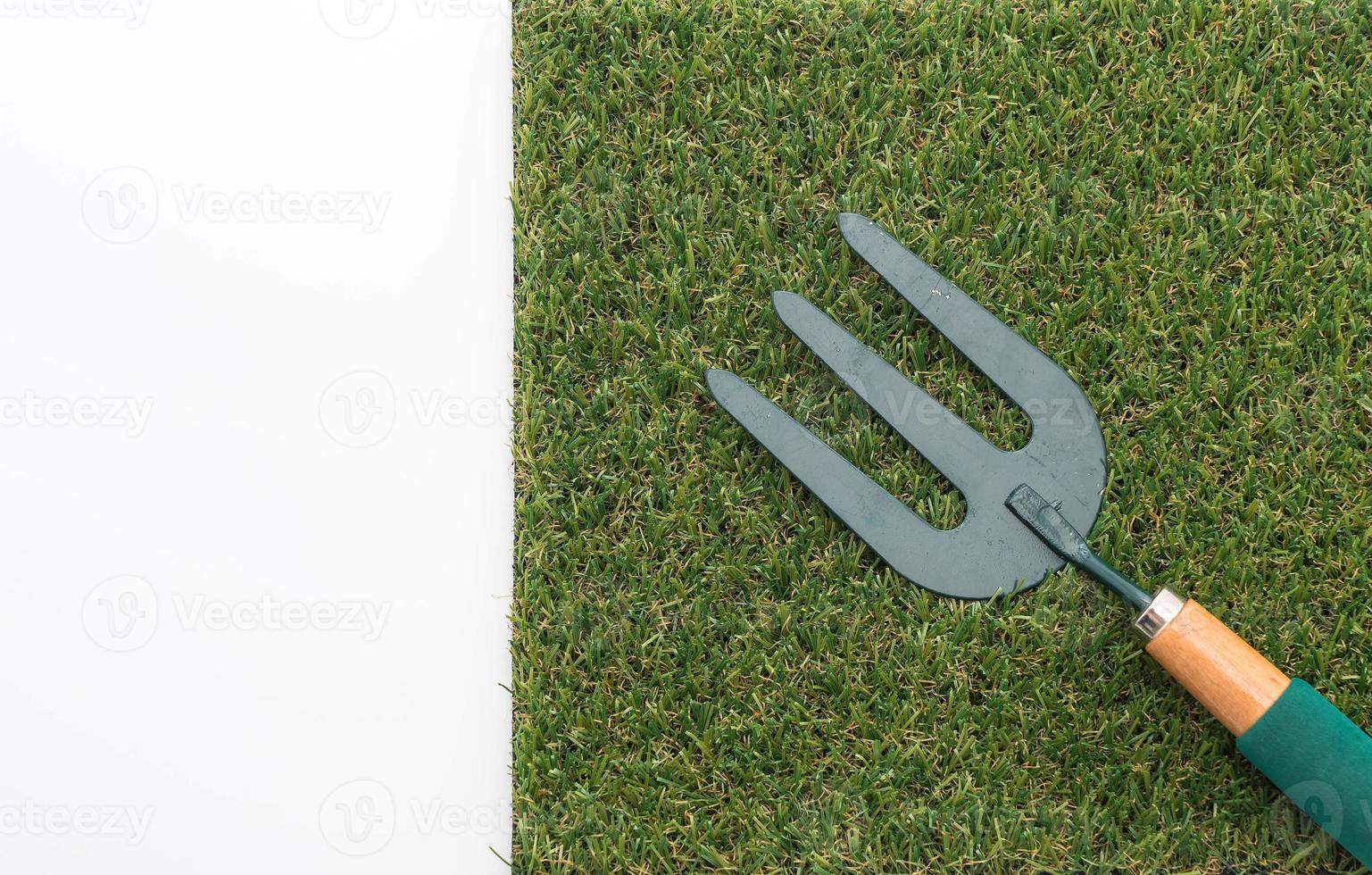 Small garden rake on grass photo