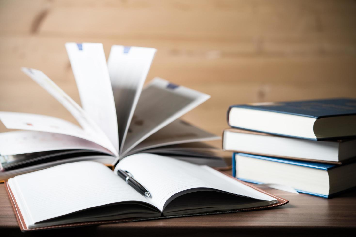 Close-up of opened books on wooden table photo