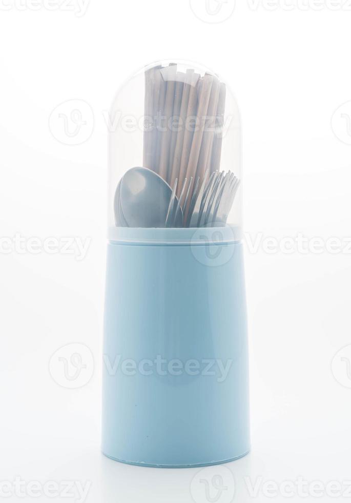 Cutlery holder with chopsticks, spoon and fork on white background photo