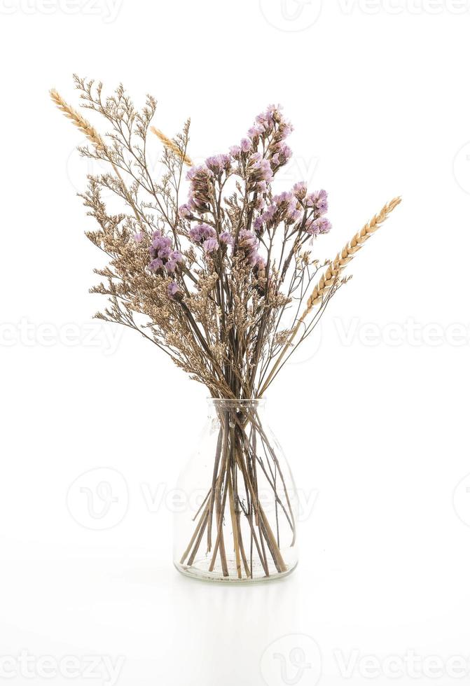 Statice and caspia flowers in a vase on white background photo