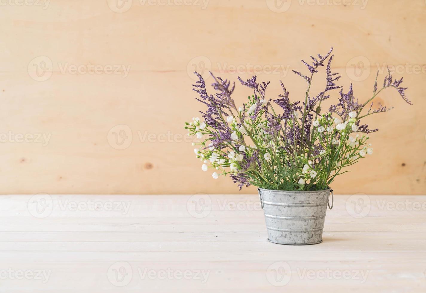 Statice and caspia flowers on wooden background photo