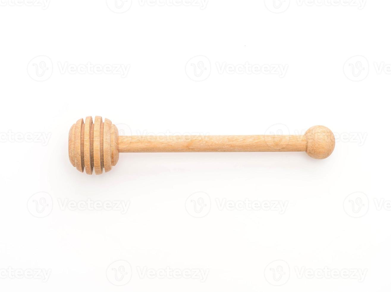 Wooden honey stick on white background photo