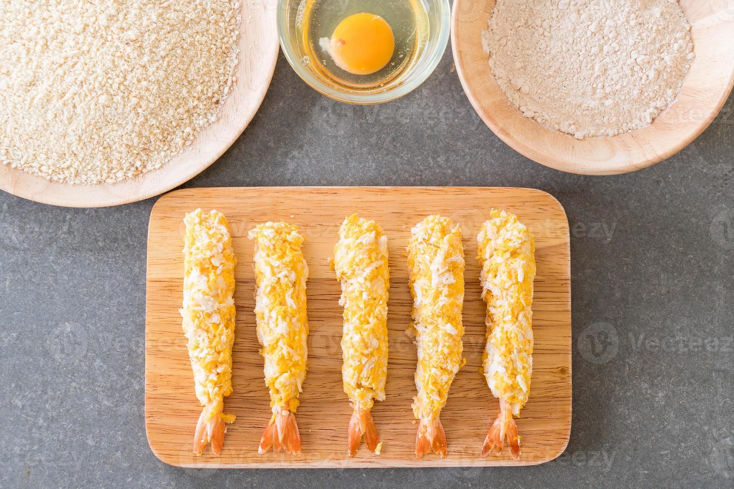 Batter fried prawns on wood board photo