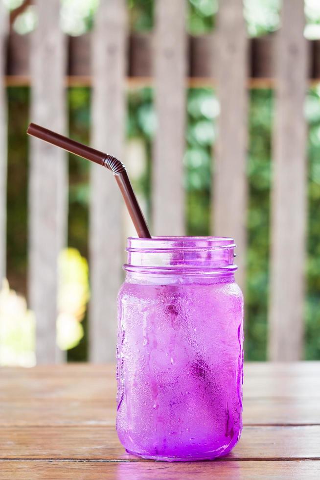 Purple glass with a straw photo