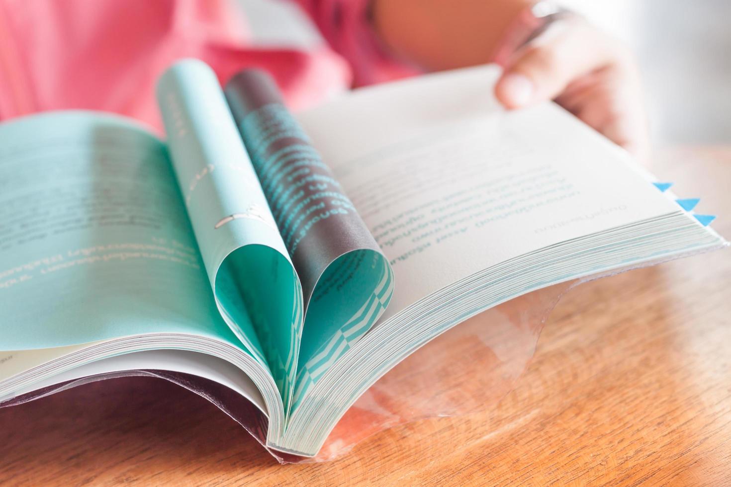 Person holding a book photo