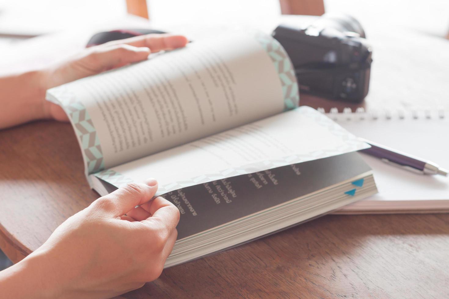 Close-up of hands holding an open book photo