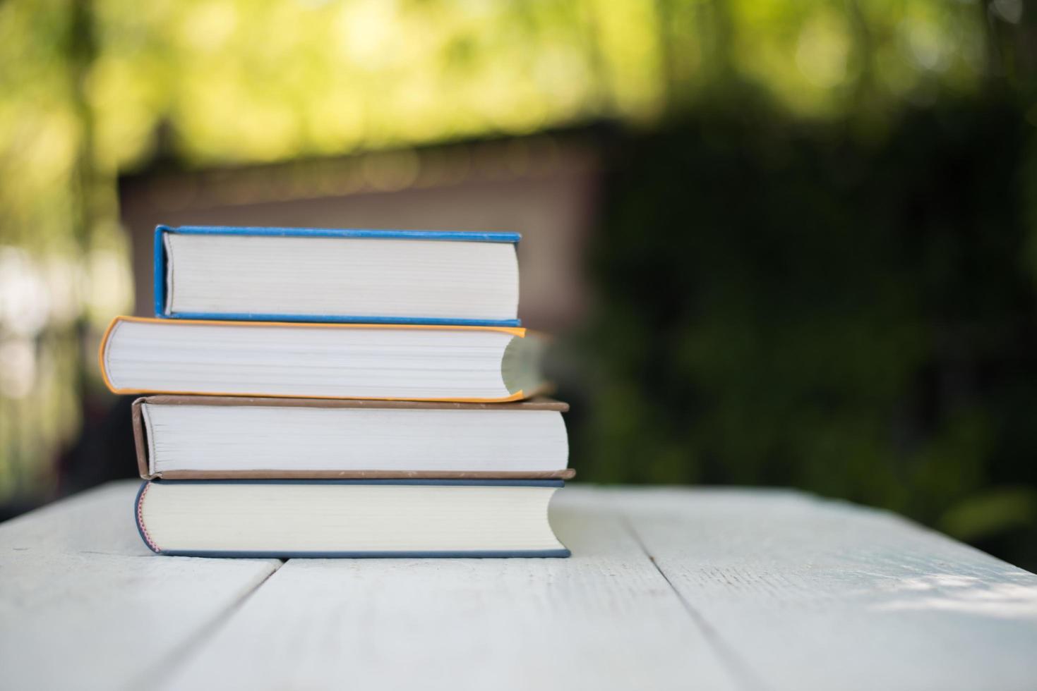 Stack of books on nature background photo