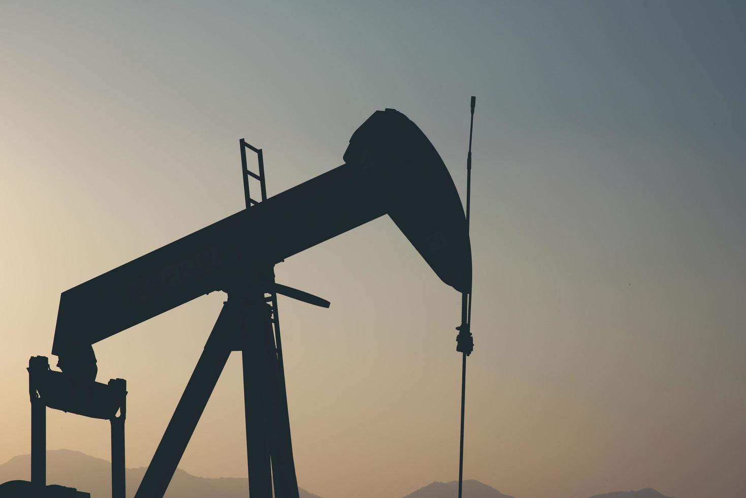 Silhouette of a construction unit in an oil field photo