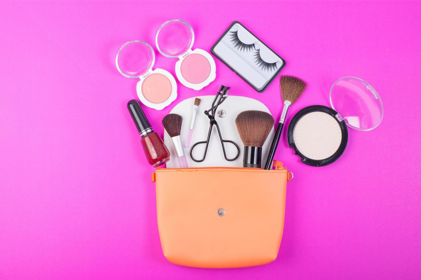 Cosmetic beauty products on pink background photo