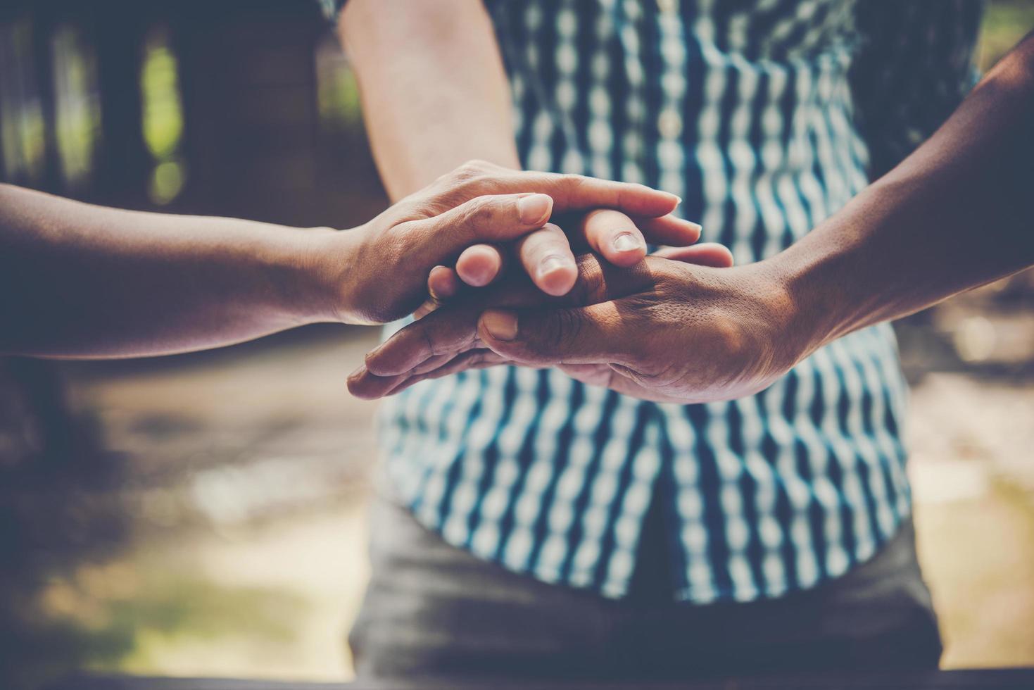 Business people putting hands together to represent teamwork photo