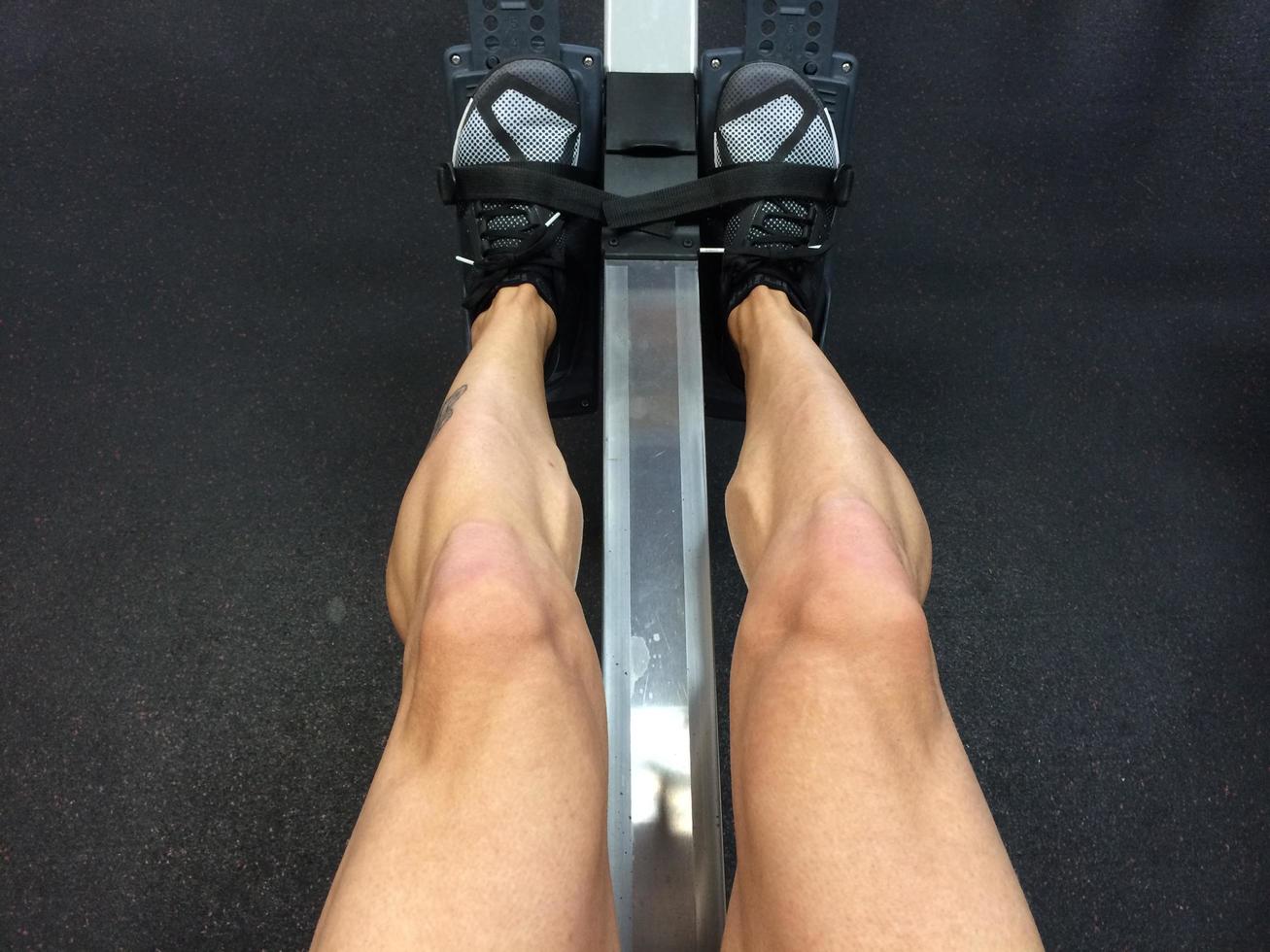 Close-up of a person sitting on a rowing machine photo