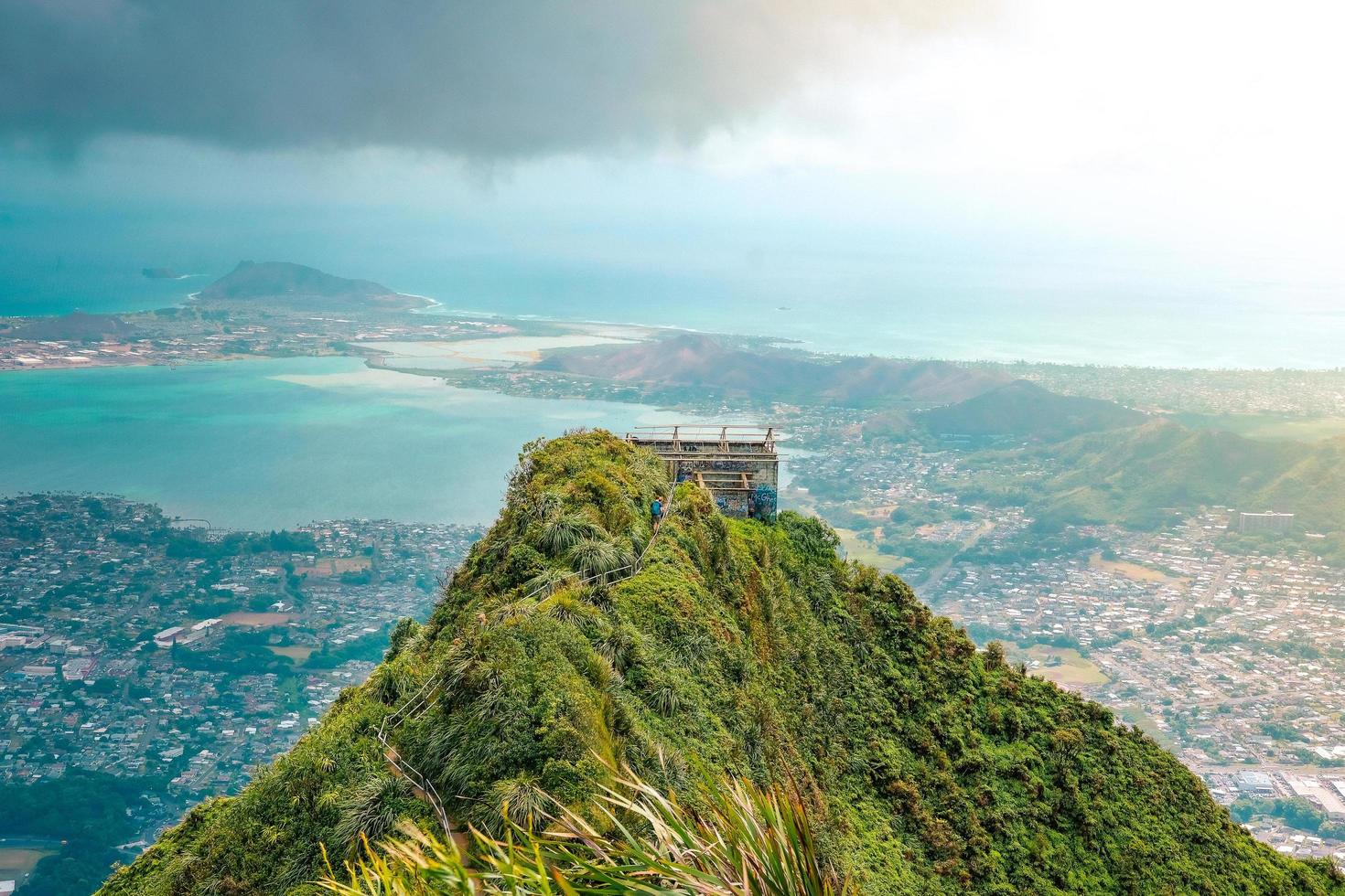 Building on top of green hill overlooking sea photo