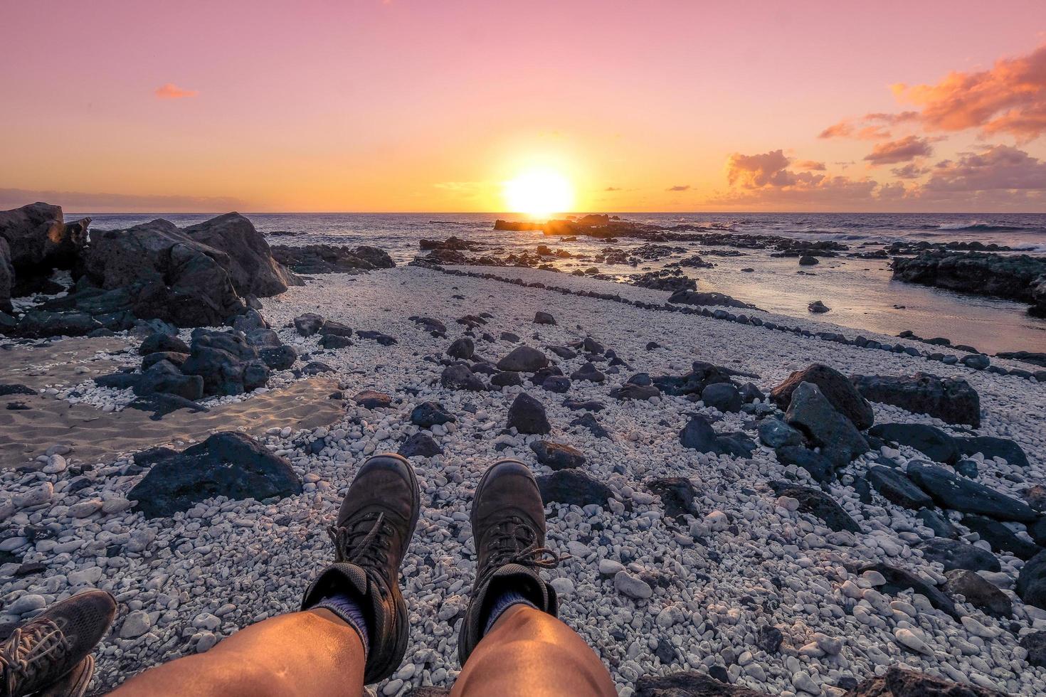 Sitting person at the sea at sunset photo