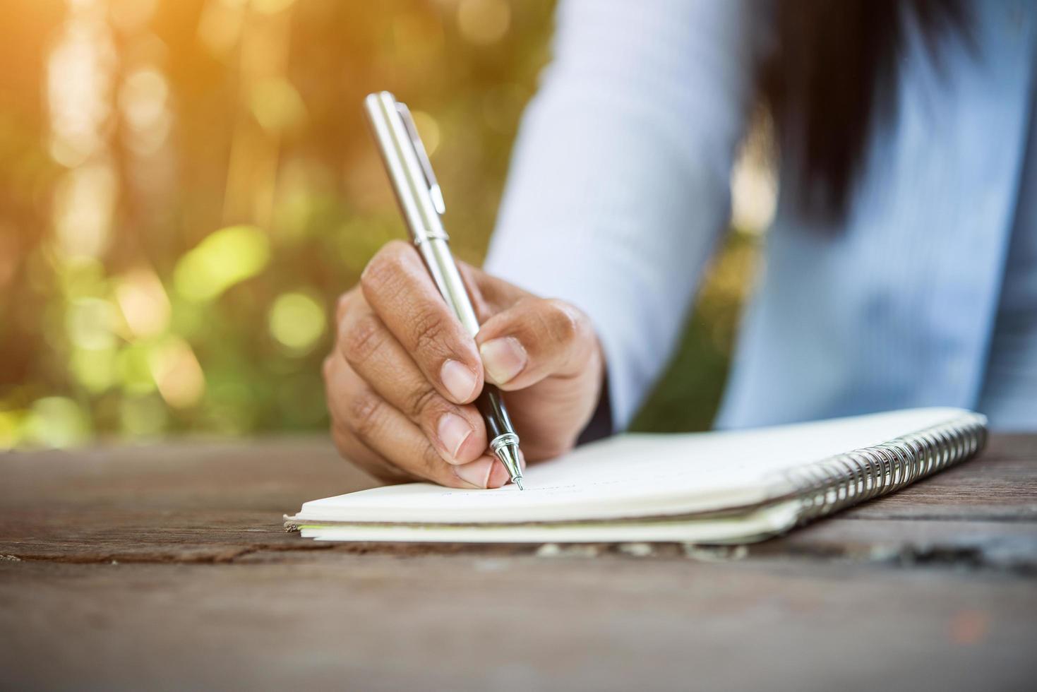 Woman writing in notebook photo