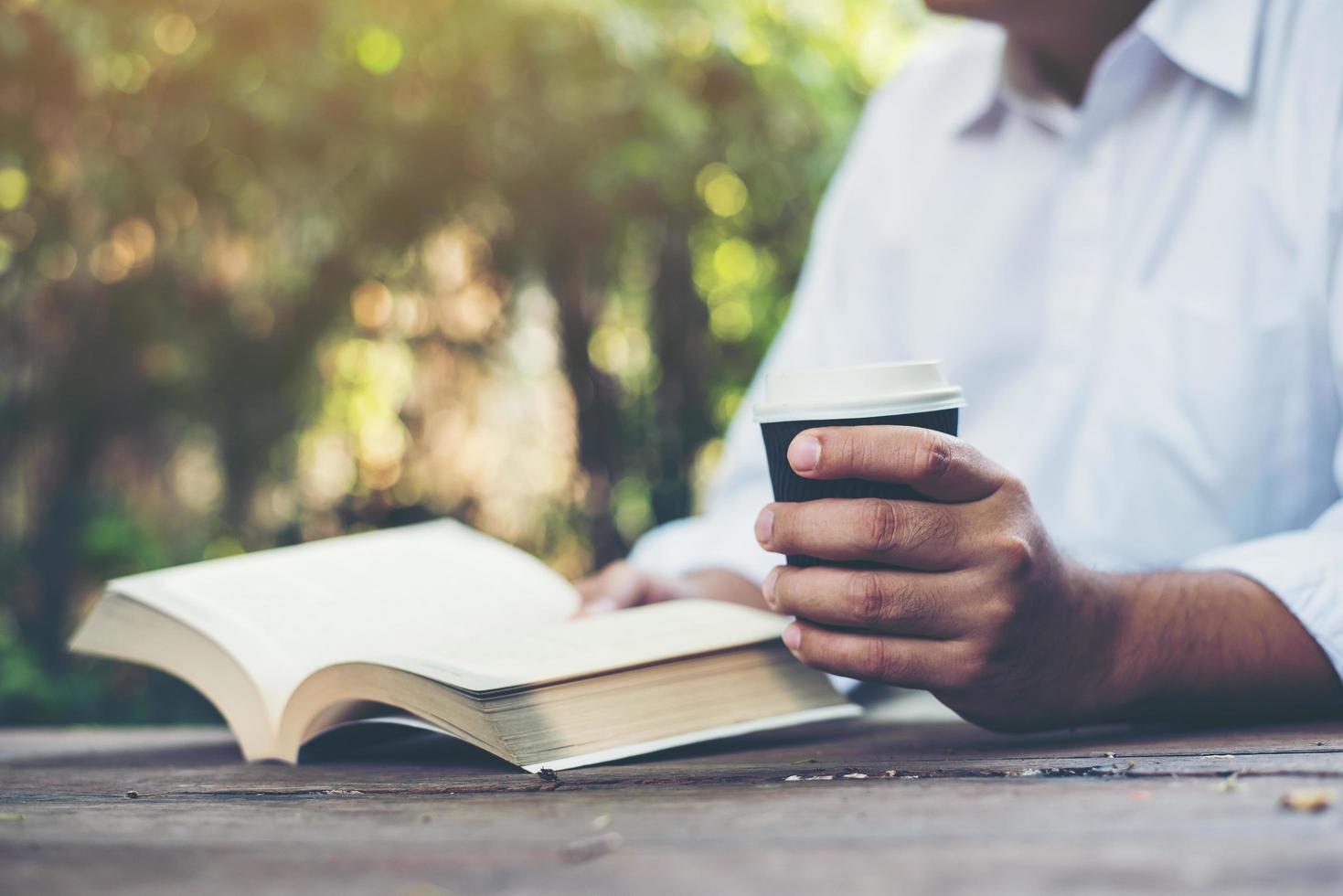 Man reading a book in his hands photo