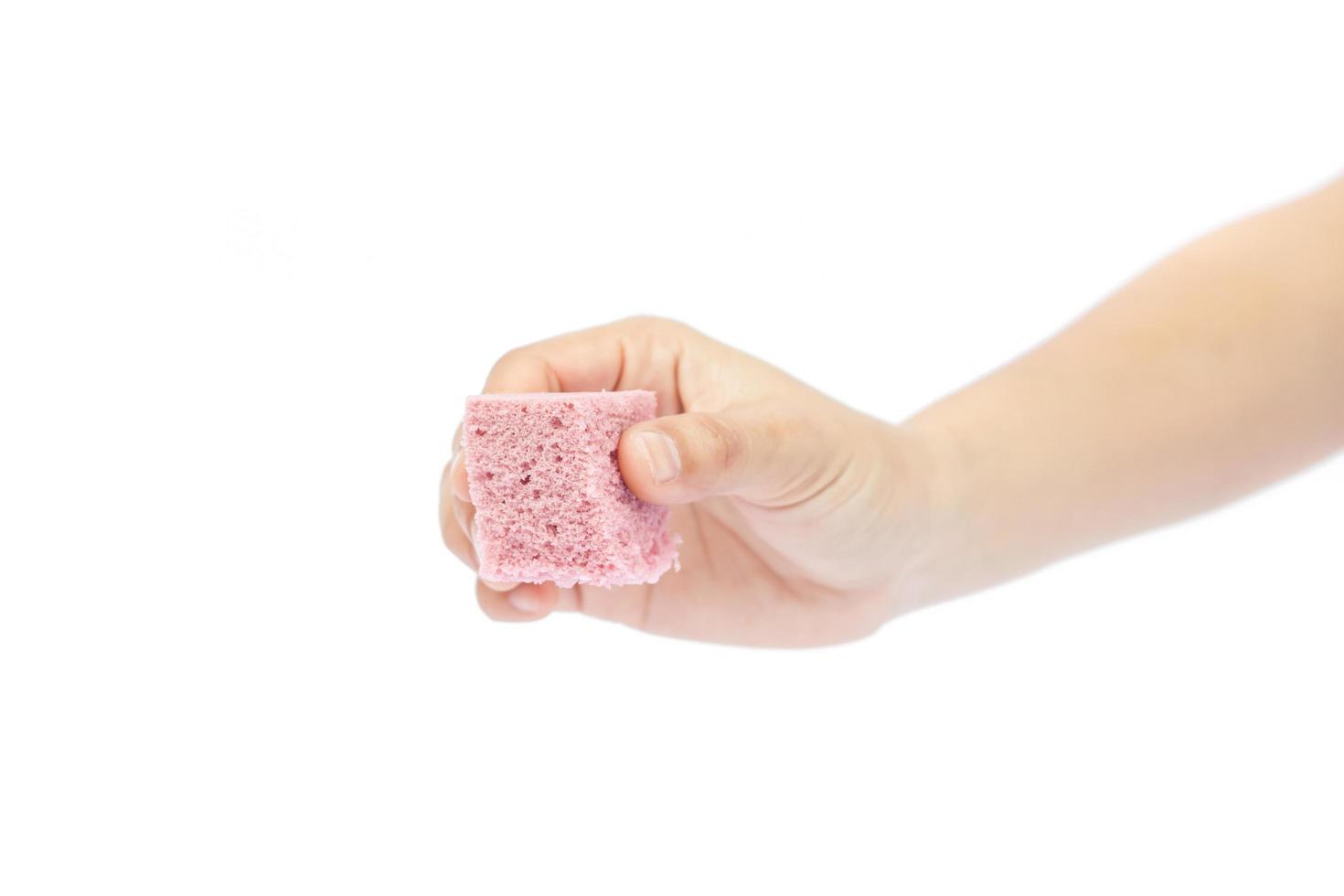 Hand holding a square cake photo