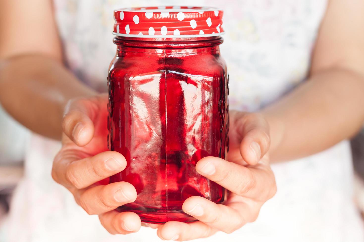 Person holding a red jar 1817507 Stock Photo at Vecteezy