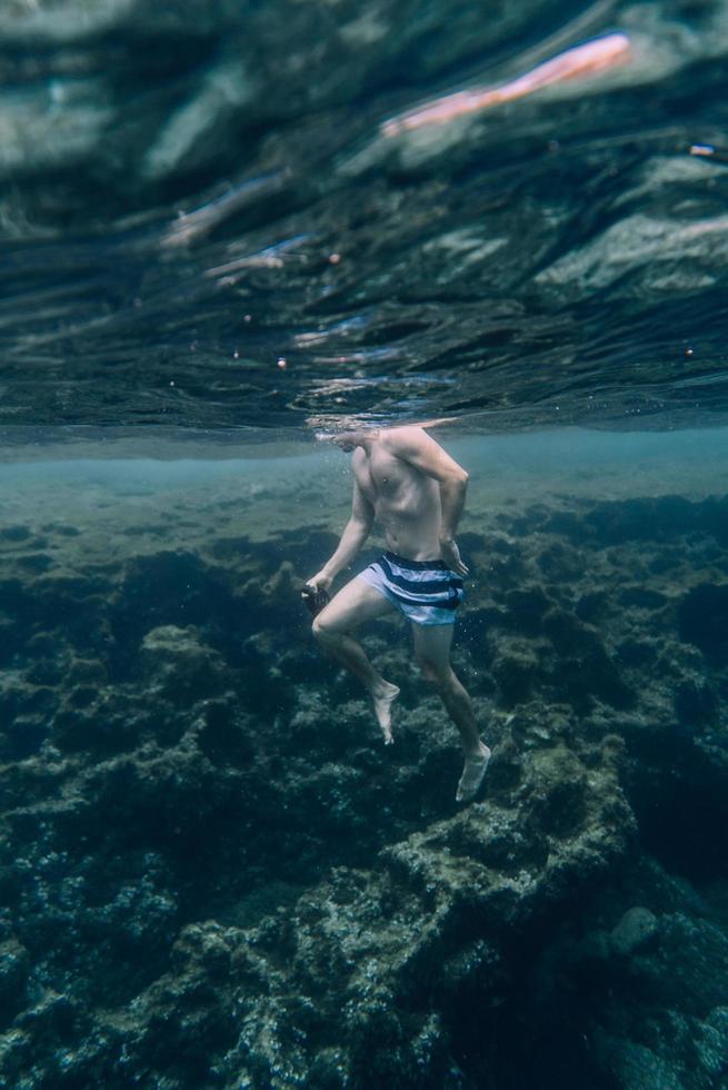hombre nadando bajo el agua foto