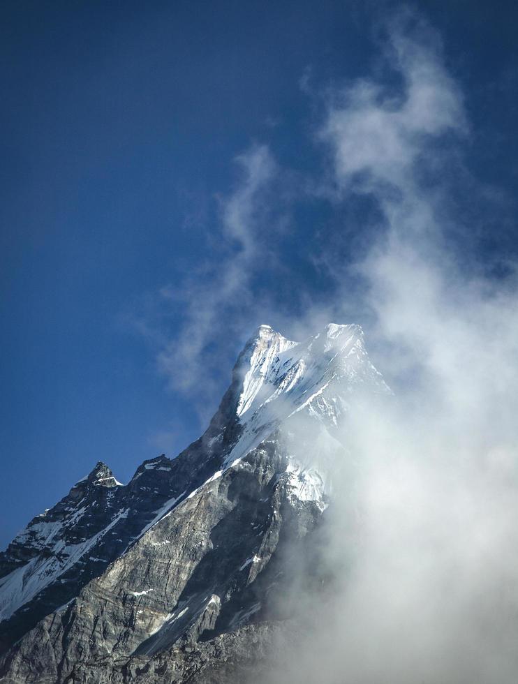 Snowy and misty mountain peak photo