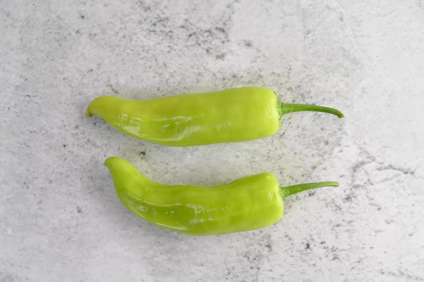 Green peppers on kitchen counter space photo