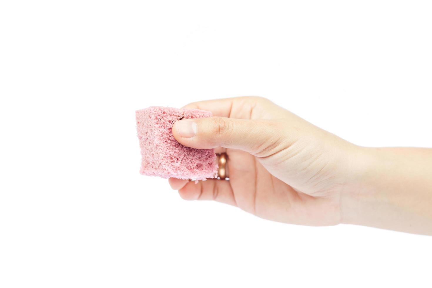 Close-up of a hand holding cake photo