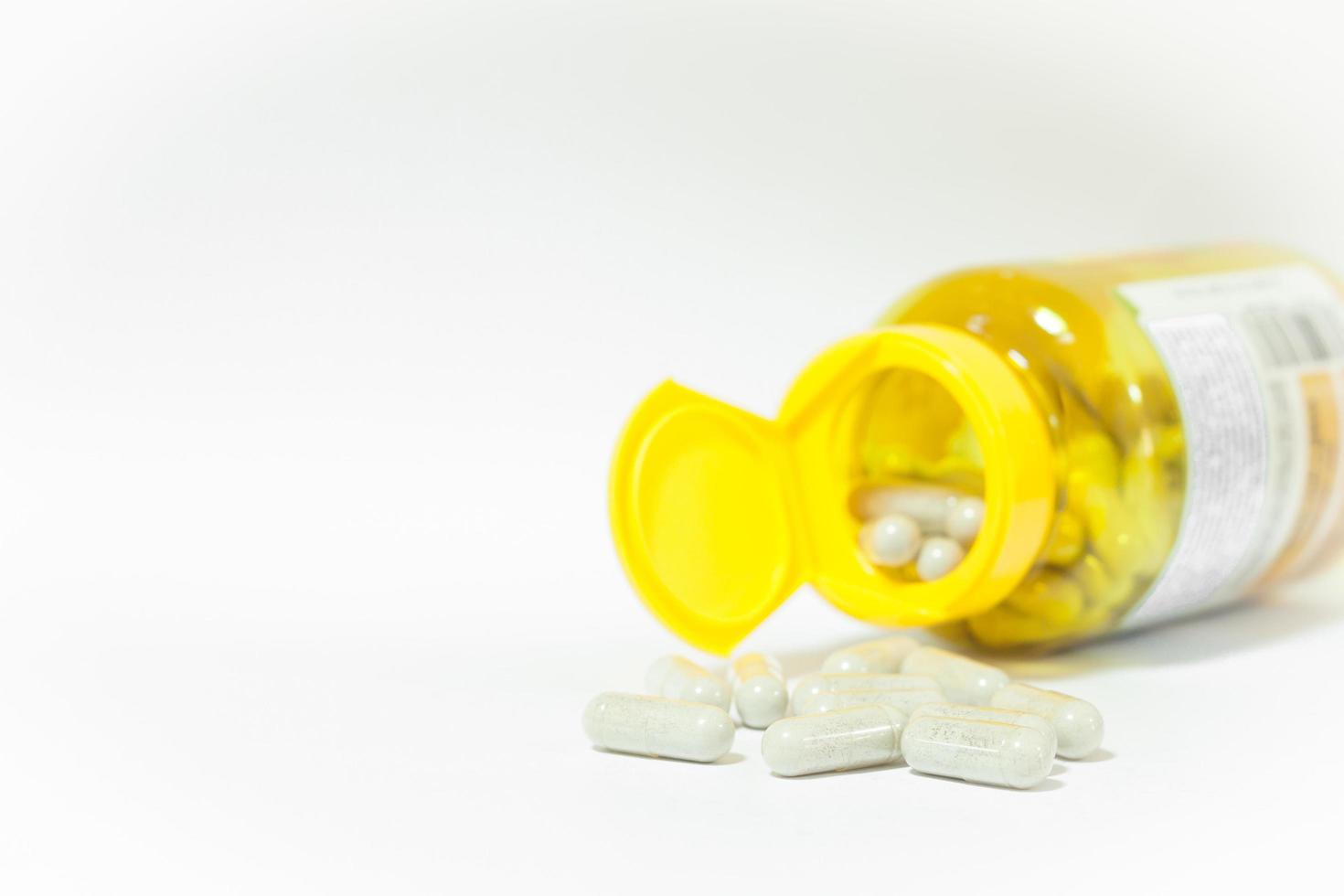 Pills with a yellow bottle and copy space photo